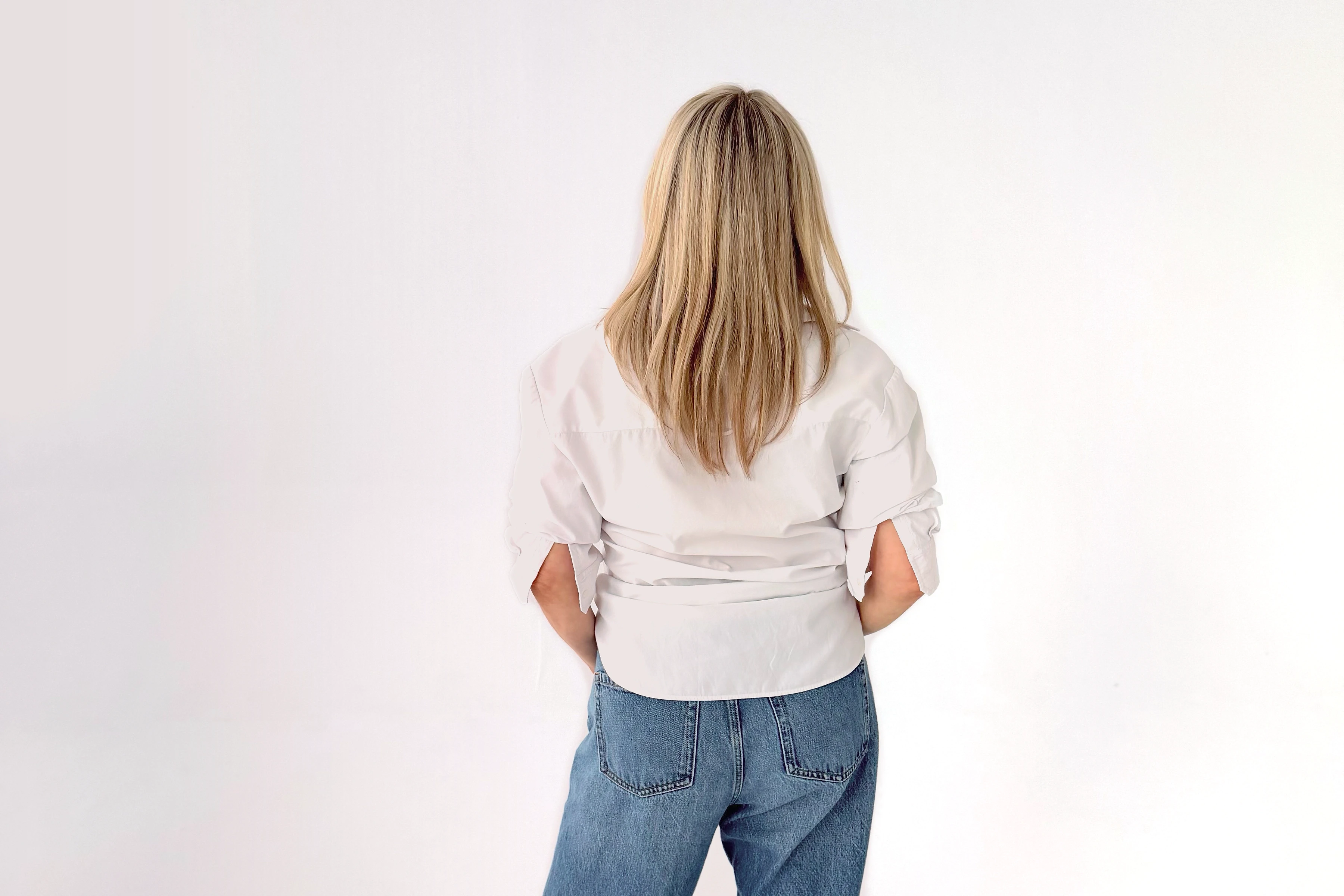 Notre ambassadrice, vue de dos, en chemise blanche et en jean. Dites-nous qui elle est.